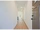 Bright hallway with hardwood floors and white walls, leading to a sunlit living area at 685 Sunstone Ln, Lawrenceville, GA 30043