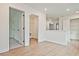 Bright hallway with hardwood floors and white trim, showing open doorways to other rooms at 685 Sunstone Ln, Lawrenceville, GA 30043