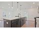 Kitchen island with a stainless steel sink, dishwasher, and pendant lights at 685 Sunstone Ln, Lawrenceville, GA 30043