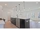 Large kitchen island with a stainless steel sink and modern pendant lighting at 685 Sunstone Ln, Lawrenceville, GA 30043