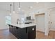 Kitchen boasts a large island, quartz countertops, and stainless steel appliances at 685 Sunstone Ln, Lawrenceville, GA 30043
