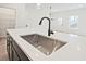 Close-up of the kitchen island's sink, faucet, and countertop at 685 Sunstone Ln, Lawrenceville, GA 30043
