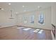Bright and airy living room with hardwood floors, a modern chandelier, and ample natural light at 685 Sunstone Ln, Lawrenceville, GA 30043