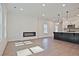 Open-concept living space with fireplace and kitchen island with barstool seating at 685 Sunstone Ln, Lawrenceville, GA 30043