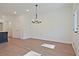 Bright living room with wood floors and a modern light fixture overhead at 685 Sunstone Ln, Lawrenceville, GA 30043