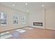 Modern living room featuring a sleek electric fireplace and hardwood floors at 685 Sunstone Ln, Lawrenceville, GA 30043