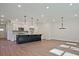 Spacious kitchen and dining area featuring modern lighting and hardwood floors at 685 Sunstone Ln, Lawrenceville, GA 30043