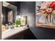 Elegant bathroom with dark vanity, large art, and modern fixtures at 1445 Sheridan Ne Walk, Atlanta, GA 30324