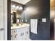 Small bathroom with a white vanity and dark-painted walls at 1445 Sheridan Ne Walk, Atlanta, GA 30324