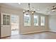 Elegant dining room with hardwood floors, chandelier, and access to backyard at 709 Trevett Way, Marietta, GA 30062