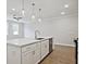 White kitchen island with stainless steel dishwasher and pendant lighting at 709 Trevett Way, Marietta, GA 30062