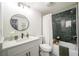 Updated bathroom with dark green tile, white vanity, and modern fixtures at 599 Quillian Ave., Decatur, GA 30032