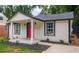 Charming craftsman bungalow with red door, covered porch, and landscaped yard at 599 Quillian Ave., Decatur, GA 30032