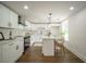 Modern white kitchen with island and stainless steel appliances at 599 Quillian Ave., Decatur, GA 30032