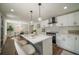 Modern kitchen with white cabinets, island, and stainless steel appliances at 599 Quillian Ave., Decatur, GA 30032