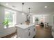 Modern kitchen island with white cabinets and quartz countertops at 599 Quillian Ave., Decatur, GA 30032