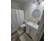 Clean bathroom with white vanity and a round mirror at 6365 Wellington Walk Way, Lithonia, GA 30058