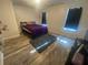 Bedroom with wood-look floors and purple bedding at 6365 Wellington Walk Way, Lithonia, GA 30058