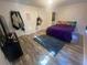 Bedroom with wood-look floors and purple bedding at 6365 Wellington Walk Way, Lithonia, GA 30058