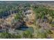 Aerial view of house and pond on a wooded lot at 595 S Mount Carmel Rd, Mcdonough, GA 30253