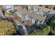 Aerial view of apartments with balconies, parking, and mature trees offering shade and greenery in a community at 201 Granville Ct, Atlanta, GA 30328