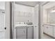 Laundry closet with washer and dryer and view to the bathroom at 201 Granville Ct, Atlanta, GA 30328