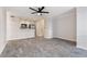 Open-concept living room featuring hardwood floors, a ceiling fan and combined kitchen at 201 Granville Ct, Atlanta, GA 30328