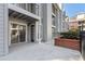 Exterior view of a private outdoor patio with sliding glass door and partial view of the complex at 201 Granville Ct, Atlanta, GA 30328