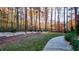 Secluded backyard with black fencing, brick accents, lush grass, and mature trees creating a tranquil setting at 271 Brooks Rackley Rd, Dallas, GA 30157