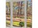 Window view of backyard featuring green grass, landscaping, and mature trees at 271 Brooks Rackley Rd, Dallas, GA 30157