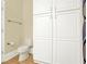 Bathroom featuring storage cabinet, toilet, towel rack, and wood-look floors at 271 Brooks Rackley Rd, Dallas, GA 30157