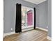 This bedroom features hardwood floors, gray walls, white trim, and a window letting in natural light at 271 Brooks Rackley Rd, Dallas, GA 30157