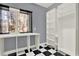 View of a closet featuring black and white floors, built-in white shelving, and a bright window at 271 Brooks Rackley Rd, Dallas, GA 30157