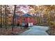 Elegant home with a private driveway, offering beautiful backyard views and surrounded by autumn foliage at 271 Brooks Rackley Rd, Dallas, GA 30157