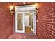 Beautiful front door with glass panels and decorative accents, sidelights, and brickwork at 271 Brooks Rackley Rd, Dallas, GA 30157