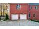 Two-car garage attached to a brick home, providing ample parking and storage space at 271 Brooks Rackley Rd, Dallas, GA 30157