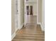 Spacious hallway featuring wood-look floors, neutral walls and an open view of a window at the end at 271 Brooks Rackley Rd, Dallas, GA 30157