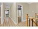 Hallway with wood floors, staircase with wood spindles, and white trim at 271 Brooks Rackley Rd, Dallas, GA 30157