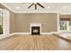 Bright living room featuring a cozy fireplace, large window, and hardwood floors at 271 Brooks Rackley Rd, Dallas, GA 30157