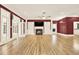 Elegant living room with fireplace, TV, and lots of natural light showcasing the hardwood floors at 271 Brooks Rackley Rd, Dallas, GA 30157