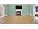 Living room boasts a fireplace, TV, and French doors leading to an ensuite bathroom and backyard view at 271 Brooks Rackley Rd, Dallas, GA 30157