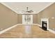 Bright living room featuring a cozy fireplace, large window, and hardwood floors at 271 Brooks Rackley Rd, Dallas, GA 30157