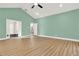 Spacious living room featuring high vaulted ceilings, light green walls, and wood-look laminate flooring at 271 Brooks Rackley Rd, Dallas, GA 30157