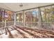 Covered porch with ceiling fan, white railings, and lovely views of trees in autumn colors at 271 Brooks Rackley Rd, Dallas, GA 30157