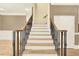 Open staircase featuring rod iron railing and hardwood steps at 271 Brooks Rackley Rd, Dallas, GA 30157