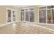 Bright sun room with tile floors and large windows that offer a view of the trees at 271 Brooks Rackley Rd, Dallas, GA 30157