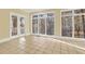 Sunroom with tile flooring, white trim, and large windows with backyard views at 271 Brooks Rackley Rd, Dallas, GA 30157