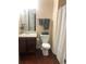 Clean bathroom with dark wood vanity, shower, and white toilet at 3554 Umatilla Sw Ln, South Fulton, GA 30331