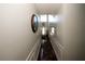 Long hallway with hardwood floors, wainscoting, and a clock at 3554 Umatilla Sw Ln, South Fulton, GA 30331