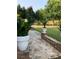 Stone pathway leading to backyard with potted plants at 3554 Umatilla Sw Ln, South Fulton, GA 30331